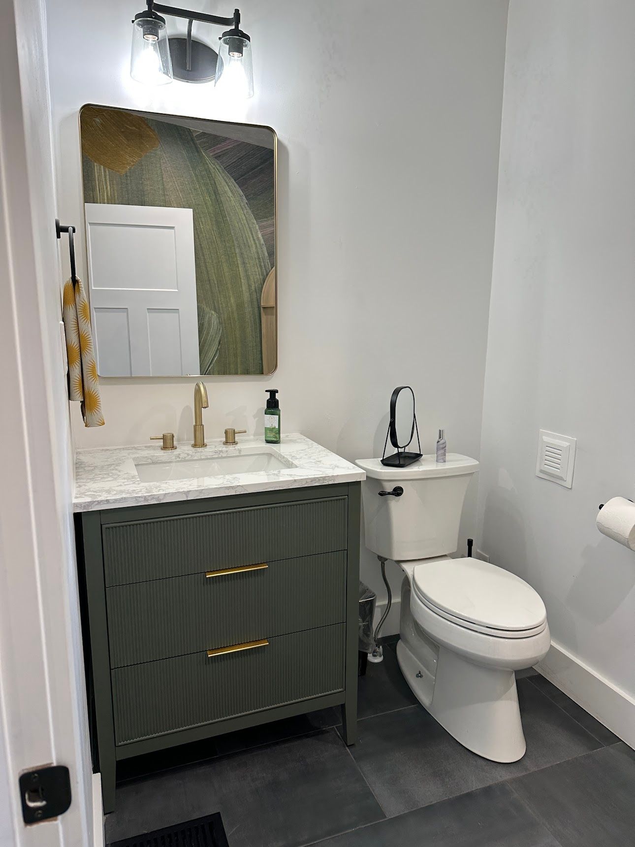 Room refresh — updated vanity, brass fixtures, tile