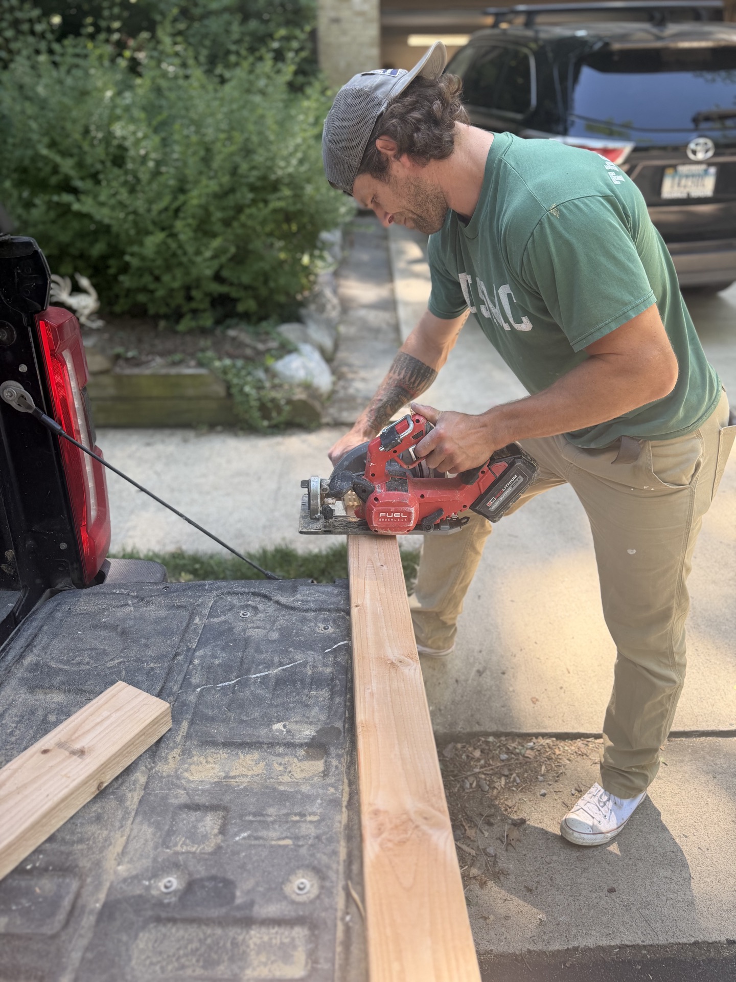 Brandon, owner of Veteran Home Solutions, cutting lumber on a project
